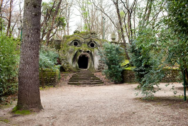 Bomarzo, Italy – January 10, 2015: The Ogre or Orcus Mouth is the most famous statue in The Park of the Monsters (Sacred Grove) of Bomarzo. Is a huge head of a man petrified by a shout.