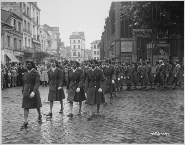 Members of the 6888th Central Postal Directory Battalion take part in a May 1945 parade ceremony in honor of Joan d’Arc at the marketplace where she was burned at the stake