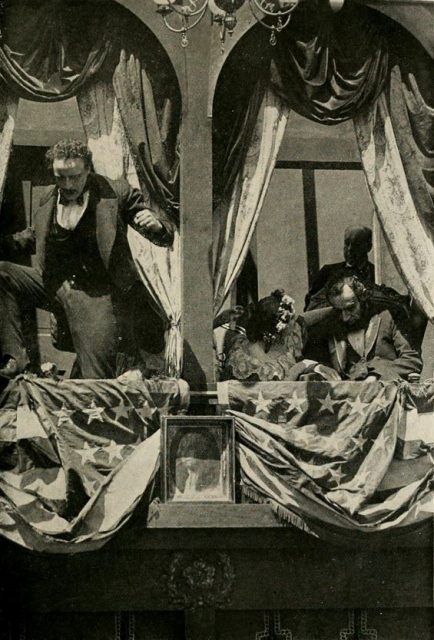 Still from the American film The Birth of a Nation (1915), with Raoul Walsh as John Wilkes Booth and Joseph Henabery as Abraham Lincoln, facing page 70 of the novel, with caption,”The Assassination”.