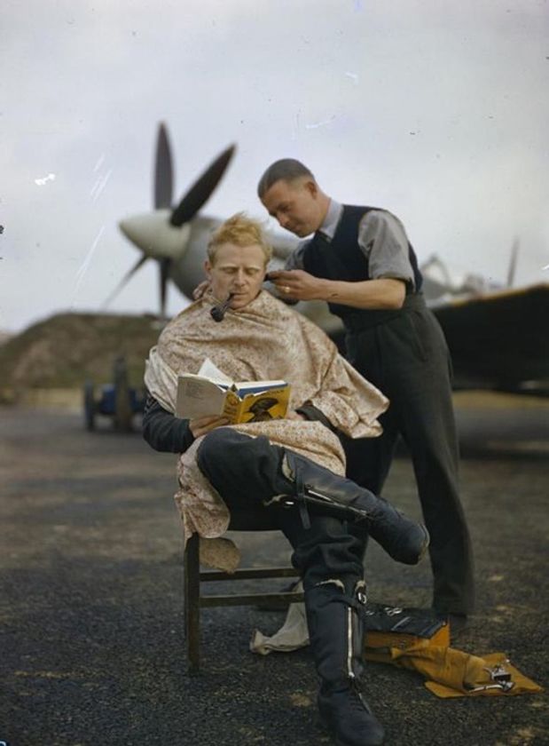 An RAF Pilot getting a haircut during a break between missions, 1942.
