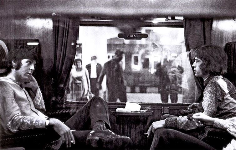 Paul McCartney and Mick Jagger in a train at Euston Station in 1967 on their way to Bangor.
