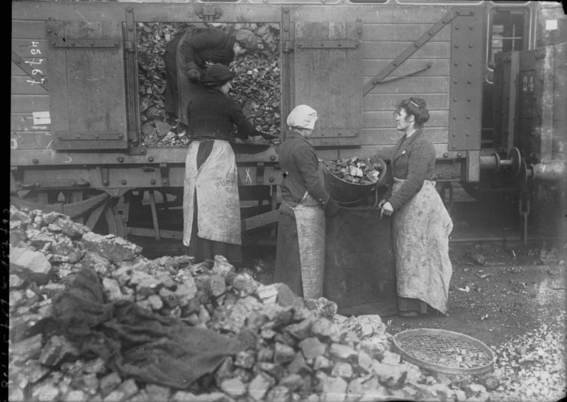 Women unloading a coal wagon England