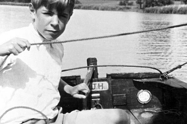 A young Stephen Hawking fishing on a boat.