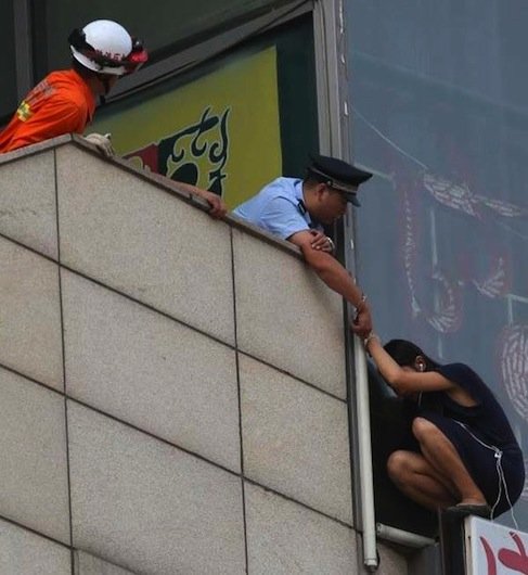 A police officer handcuffs himself to a woman threatening to jump and saves her life.