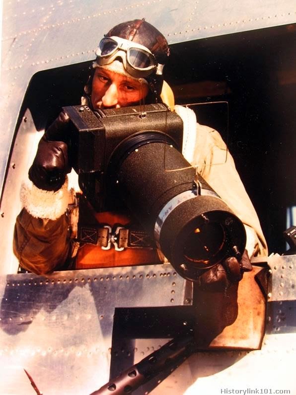 First man to obtain invasion day photographs is cameraman Captain Dale E. Bikinis, shown with his specially constructed camera.