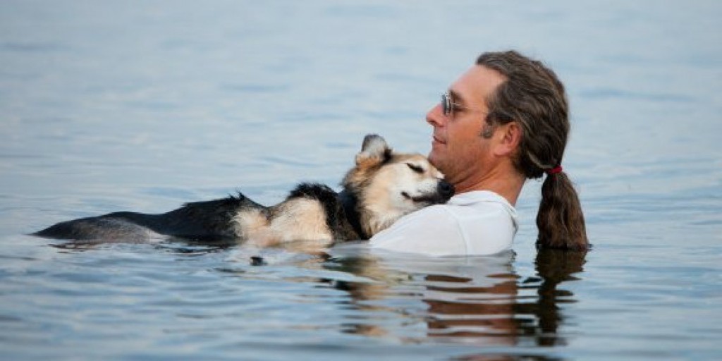 John Unger cradles his 19-year-old dog Schoep to sleep every night in Lake Superior so the buoyancy of the water can sooth his arthritic pain.