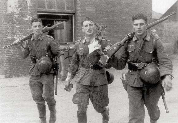 Three German soldiers returning from a recent fight