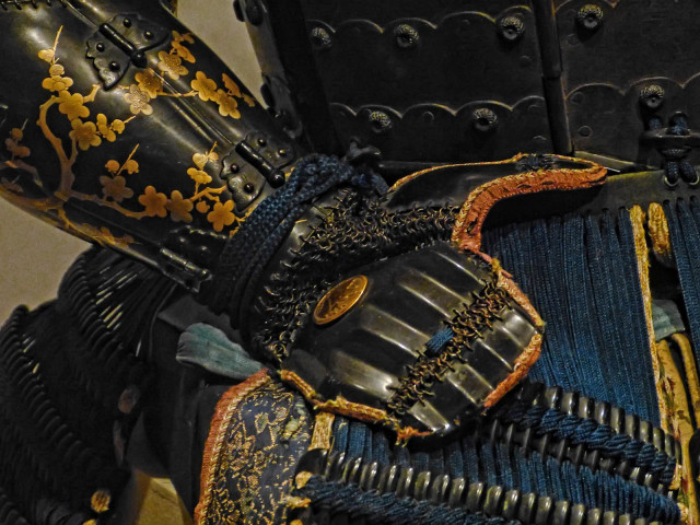 Closeup of the sleeves and hand guard embellished with gold lacquered plant motifs of the Yokohagidō Armor 18th century CE Japan.