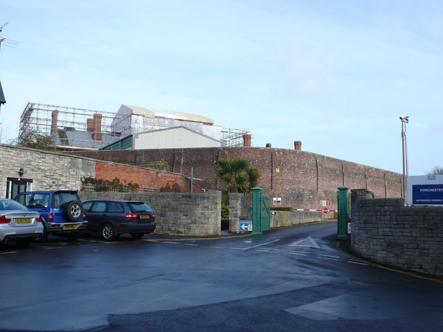 Dorchester Prison A view of the main outside gates of the prison. The security gates cannot be seen and are built into the main wall. The roof is currently being renewed. Source