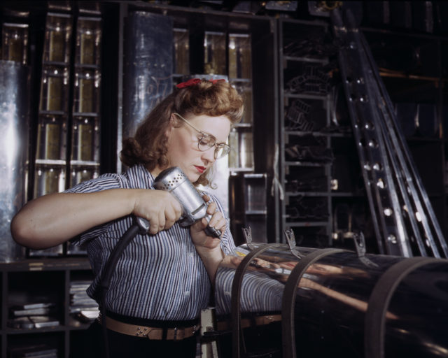 A North American Aviation employee assembles a section of the leading edge for the horizontal stabilizer of a plane at the plant in Inglewood, California.