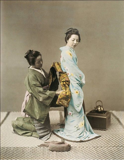 A geisha tying the obi c. 1890.Source