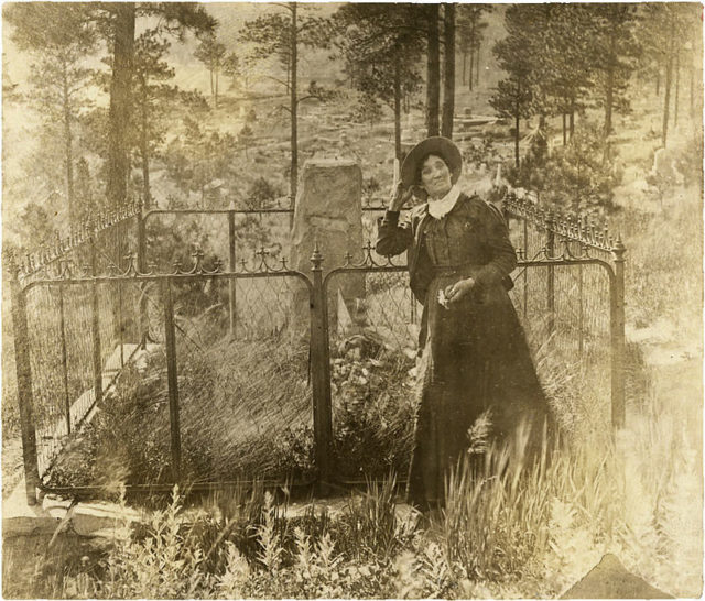 Calamity Jane at Wild Bill Hickok's Gravesite,  Deadwood, Dakota Territory.Source