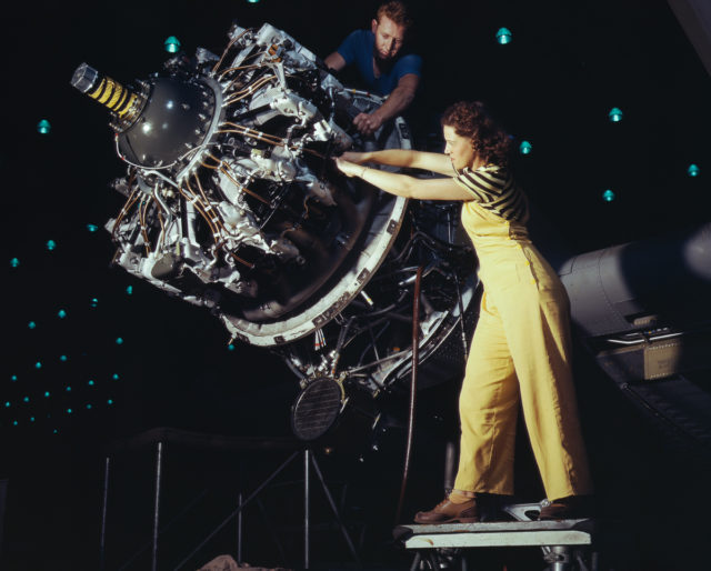 Douglas Aircraft Company employees work an airplane motor at the plant in Long Beach, California.