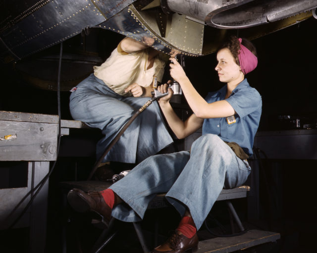 Douglas Aircraft Company employees work on the belly of a bomber at the plant in Long Beach, California.