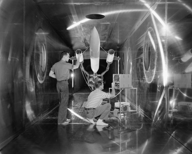 Engineers make a check of a model of a supersonic aircraft before a test run in the 10 x 10-foot Supersonic Wind Tunnel test section.