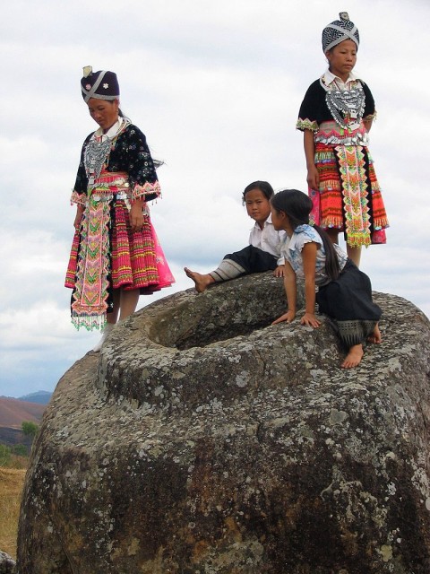 Hmong Girls climbing on one of the jars at Site.source