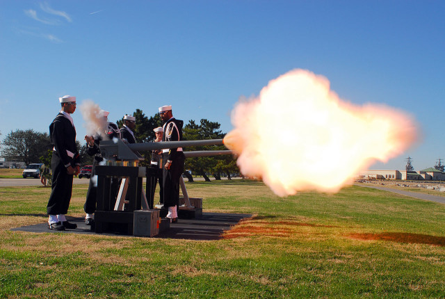 The Navy Munitions Command, detachment Sewells Point, performs a 21-gun salute at Iowa Point.Source