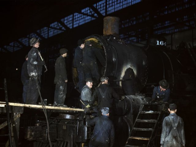 Men work on a locomotive at the 40th Street shop of the Chicago & North Western Railroad..