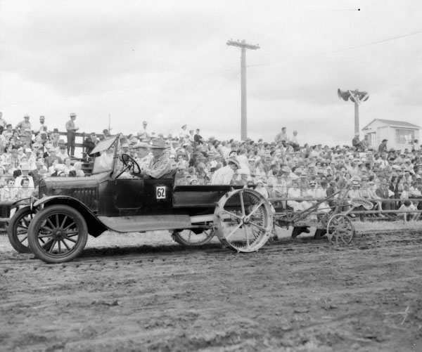 A Model T homemade tractor pulling a plowSource