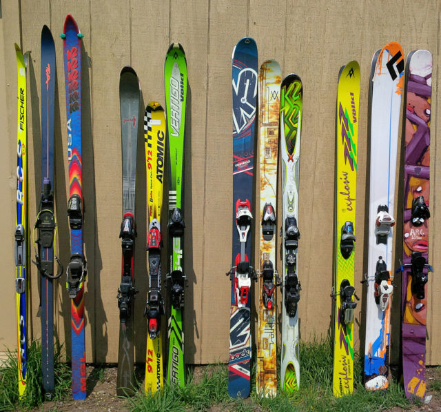 A collection of differing types of alpine skis, with nordic and telemark skis at far left. Source
