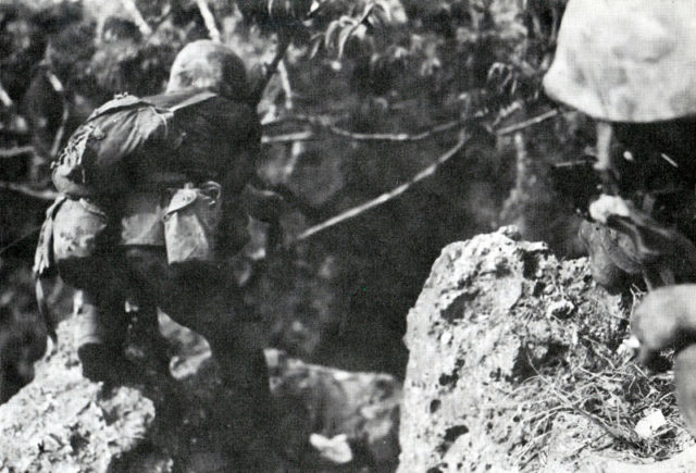 A US Marine moves cautiously through the jungle of Saipan. Source
