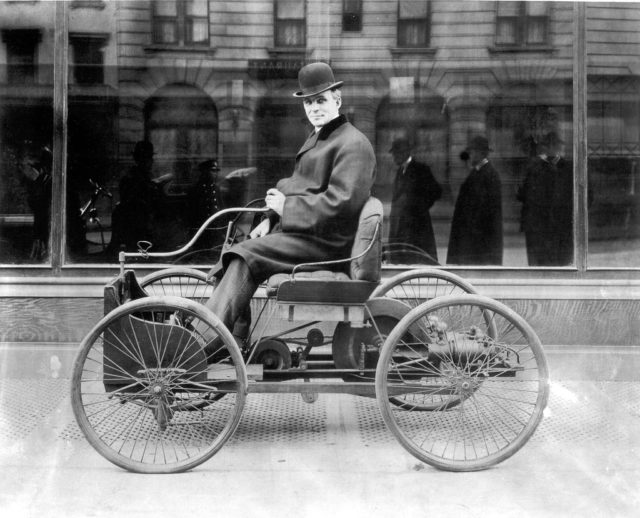 Henry Ford sits in his first automobile, the Ford Quadricycle, in 1896.Source