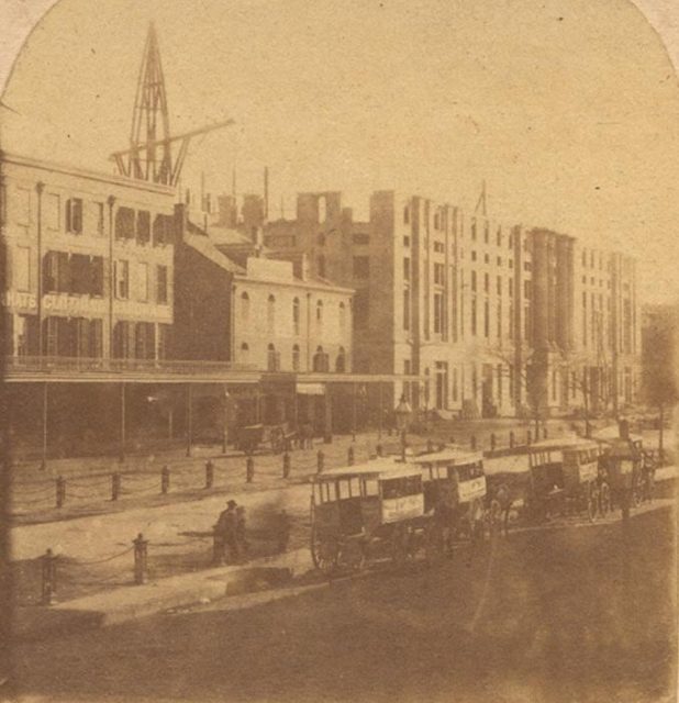 The Federal Customhouse under construction, 18 November, 1860. Horse drawn omnibuses seen lined on Canal Street.Source
