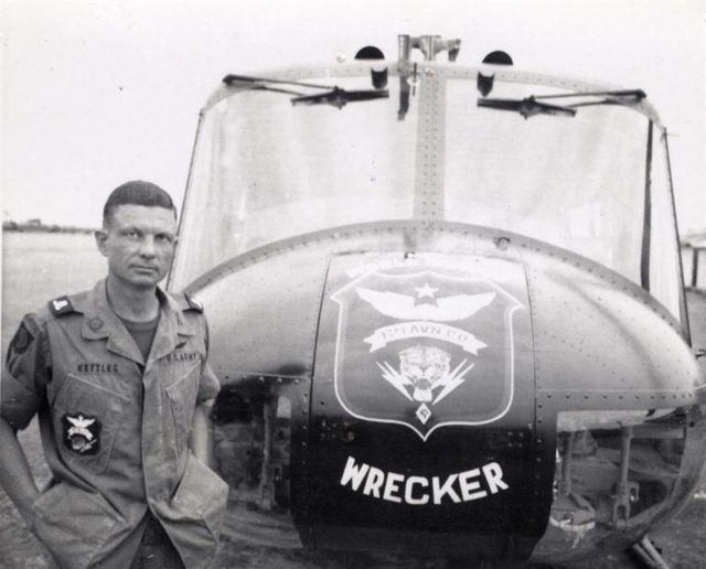 . Charles Kettles stands in front of a 121st Aviation Company UH-1H Huey helicopter during his second tour of duty in Vietnam in 1969. Source:wikipedia/public domain