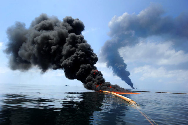 Dark clouds of smoke and fire emerge as oil burns during a controlled fire in the Gulf of Mexico, 6 May 2010