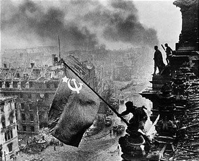 Raising a flag over the Reichstag, by Yevgeny Khaldei but with smoke added Source