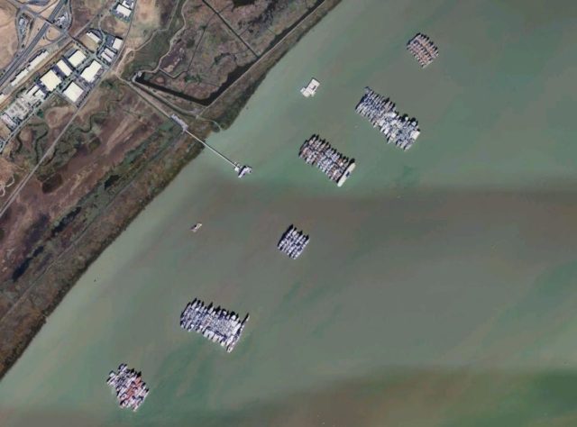 USGS aerial photo montage of “nests“ of anchored USNR ships at the National Defense Reserve Fleet in Suisun Bay, California. By USGS/Wikipedia/Public Domain
