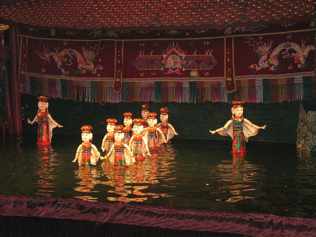 Using large rods to support the puppets it appeared as if they were moving across the water with the puppeteers hidden behind a screen. Source