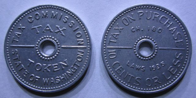 An aluminum sales tax token from the state of Washington, valued at 2 mills (1⁄5 cent) and good for the tax on purchase of 10 cents or less under the state's 2% retail sales tax law. By $1LENCE D00600D at English Wikipedia, CC BY-SA 3.0, https://commons.wikimedia.org/w/index.php?curid=32892061