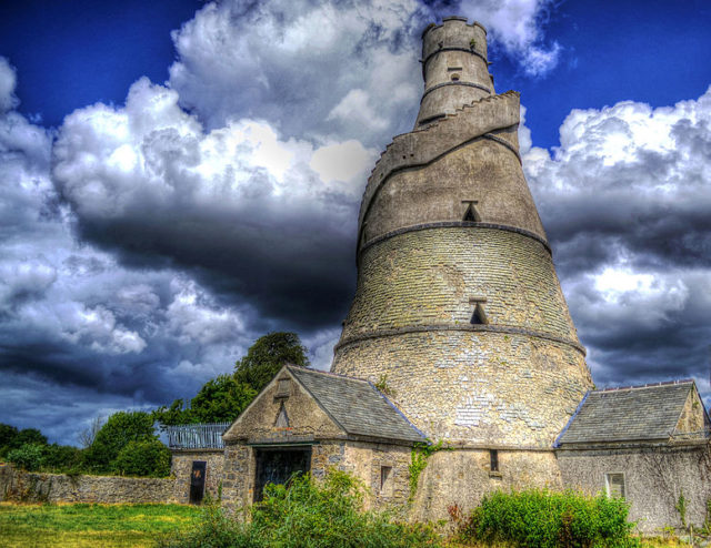 It is a tall conical structure with seven floors (some used as living quarters for servants) and central holes in the floors for use as a Granary Barn. Photo Credit