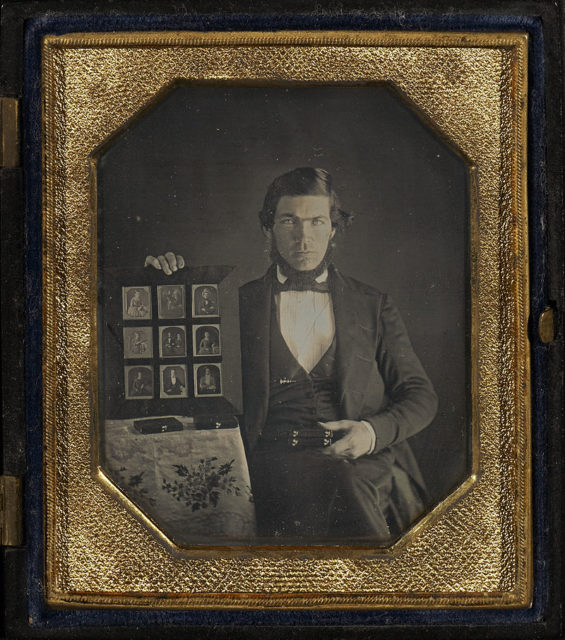 Portrait of a Daguerreotypist Displaying Daguerreotypes and Cases. Wikipedia/Public Domain