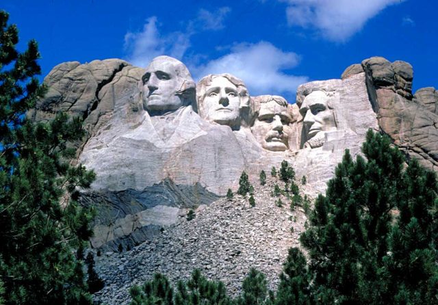 The granite remains from the construction of Mount Rushmore are still visible below the heads of the Presidents. Source: Wikipedia/Public Domain
