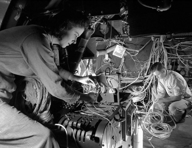 This woman is busy installing miles of wiring at the Flight Engineer's panel