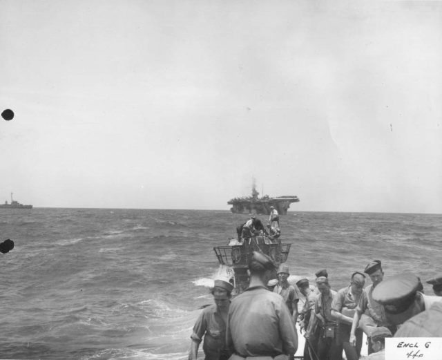View from the bow of sub showing salvage crew and carrier in background.