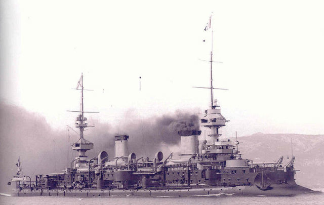 French battleship Massena, commissioned in 1898, showing typical French tumblehome, massive masts, and a plethora of long-barreled cannons.