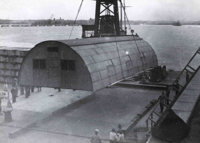 A Quonset hut being put in place at the 598th Engineer Base Depot in Japan, post-World War II. Photo Credit