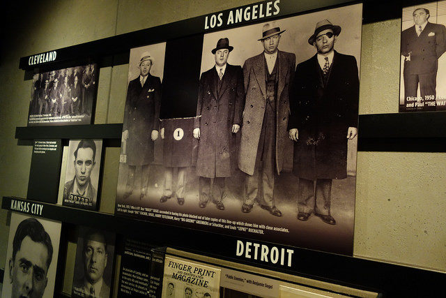 A collection of photos of notorious mobsters throughout various decades of organized crime. Photo Credit