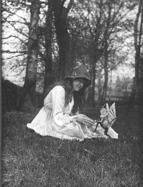 The second of the five photographs, showing Elsie with a winged gnome. Photo credit