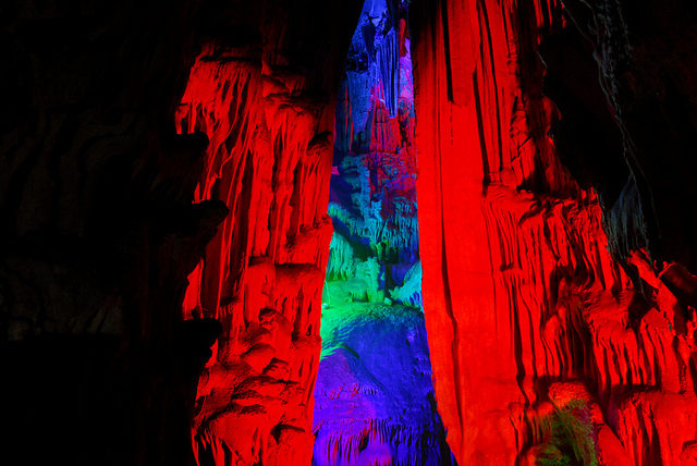 Illuminated by the colored lights, the cave looks like a dazzling underground palace. Photo Credit