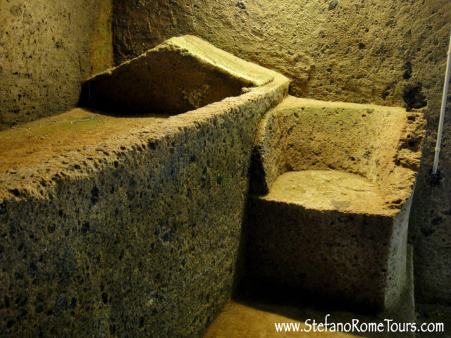 Interior of an Etruscan tuffa carved tomb inside a round mound. Photo Credit