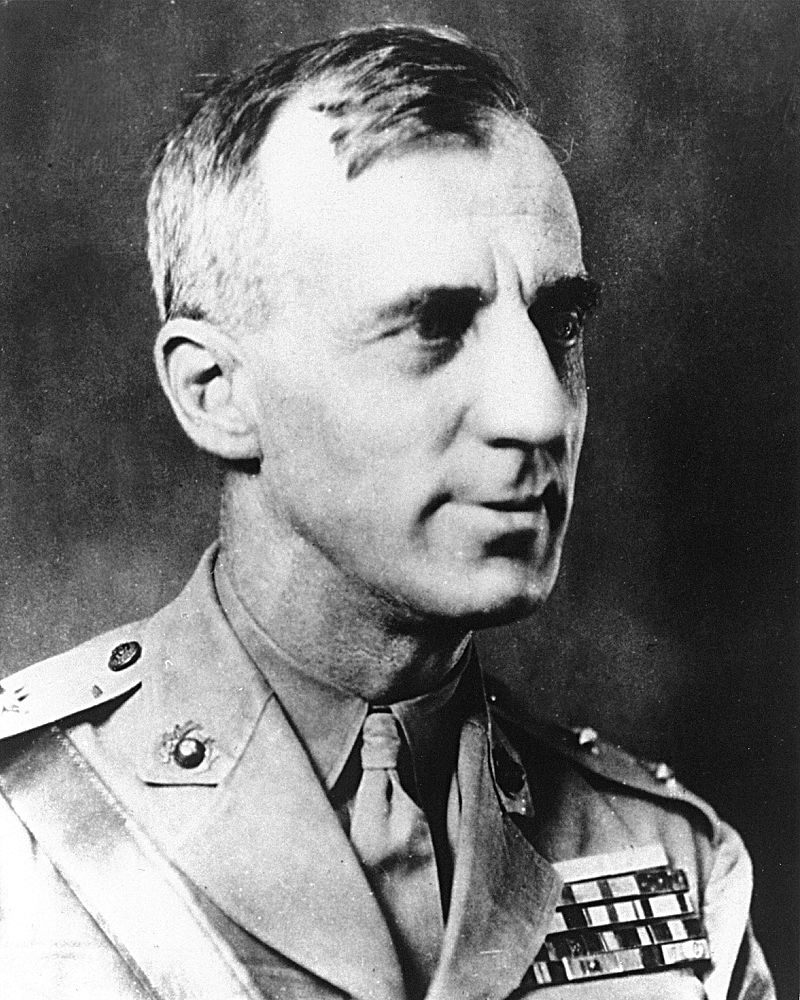 A picture of a double medal of honor recipient Smedley Butler. (Note that the light blue ribbons (at the top of his ribbon rack) appear almost white in this overexposed photo.)