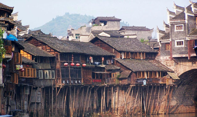 Timber structured stilt houses line along the river. Photo Ctedit