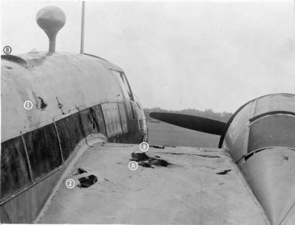Close-up of the damage caused to Vickers Wellington Mark IC, L7818 ‘AA-V’, of No. 75 (New Zealand) Squadron RAF, at Feltwell, Norfolk, after returning from an attack on Munster, Germany, on the night of 7/8 July 1941. While over the Zuider Zee, cannon shells from an attacking Messerschmitt Me 110 struck the starboard wing (A), causing a fire from a fractured fuel line which threatened to to spread to the whole wing. Efforts by the crew to douse the flames failed, and Sergeant James Allen Ward, the second pilot, volunteered to tackle the fire by climbing out onto the wing via the astro-hatch (B). With a dinghy-rope tied around his waist, he made hand and foot-holds in the fuselage and wings (1, 2 and 3) and moved out across the wing from where he was eventually able to extinguish the burning wing-fabric. His courageous actions earned him the Victoria Cross. He was shot down and killed while bombing Hamburg on the night of 15/16 September 1941, in another Wellington of the Squadron Photo Credit