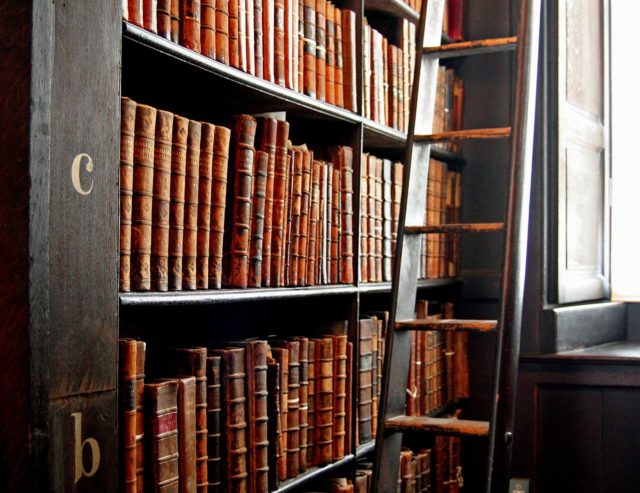Words in leather and wood. Bookshelves in the “Long Room” at the old Trinity College Library in Dublin. Photo Credit