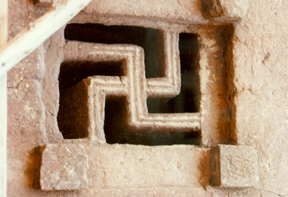 Swastika symbol carved on the window of Lalibela Rock hewn churches, Ethiopia. Photo Credit