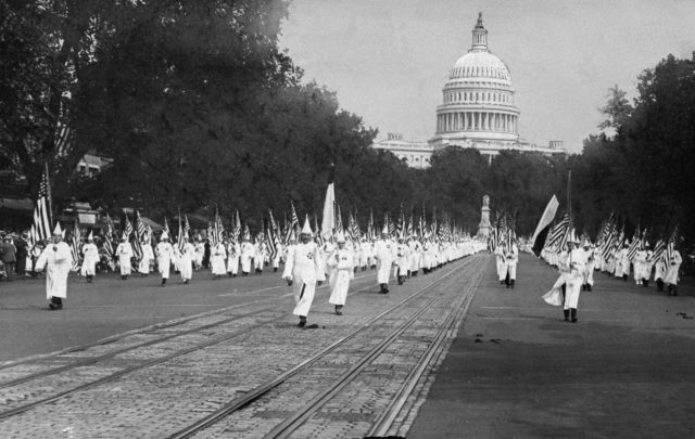 Ku Klux Klan members march in a parade along Pennsylvania Ave. in Washington D.C